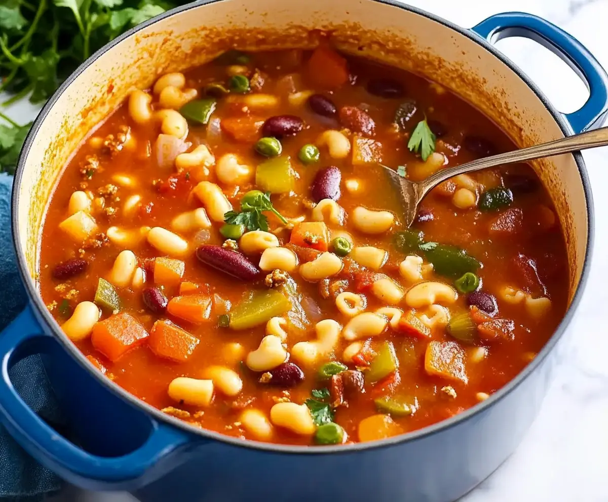 Simmering a minestrone soup recipe in a large pot.